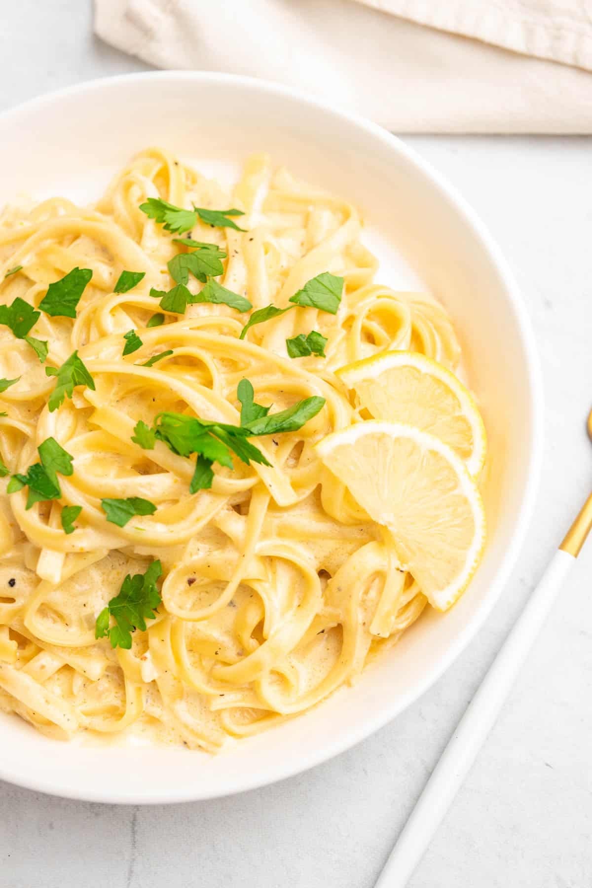 instant pot creamy pasta in a white plate with garnishes 
