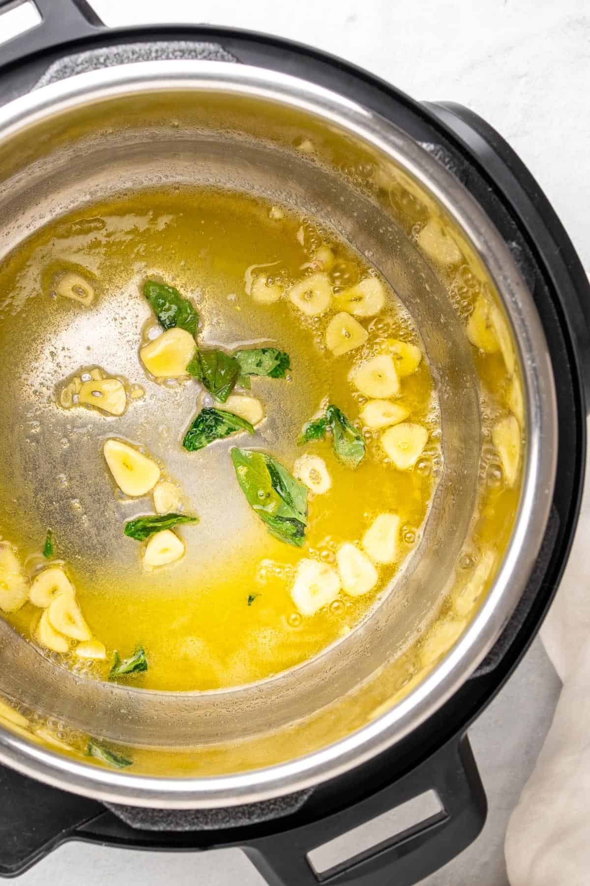 infusing the butter with garlic and fresh herbs in the instant pot