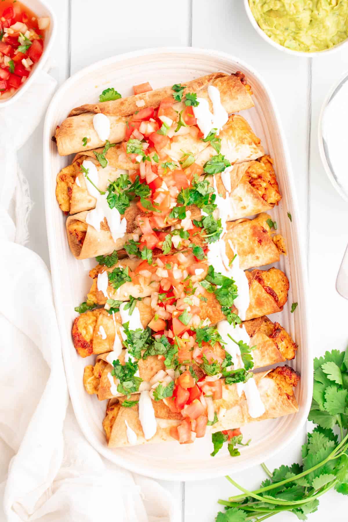 flautas with fresh salsa and sour cream as toppings