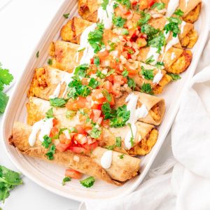 featured image of the chicken taquitos with the toppings
