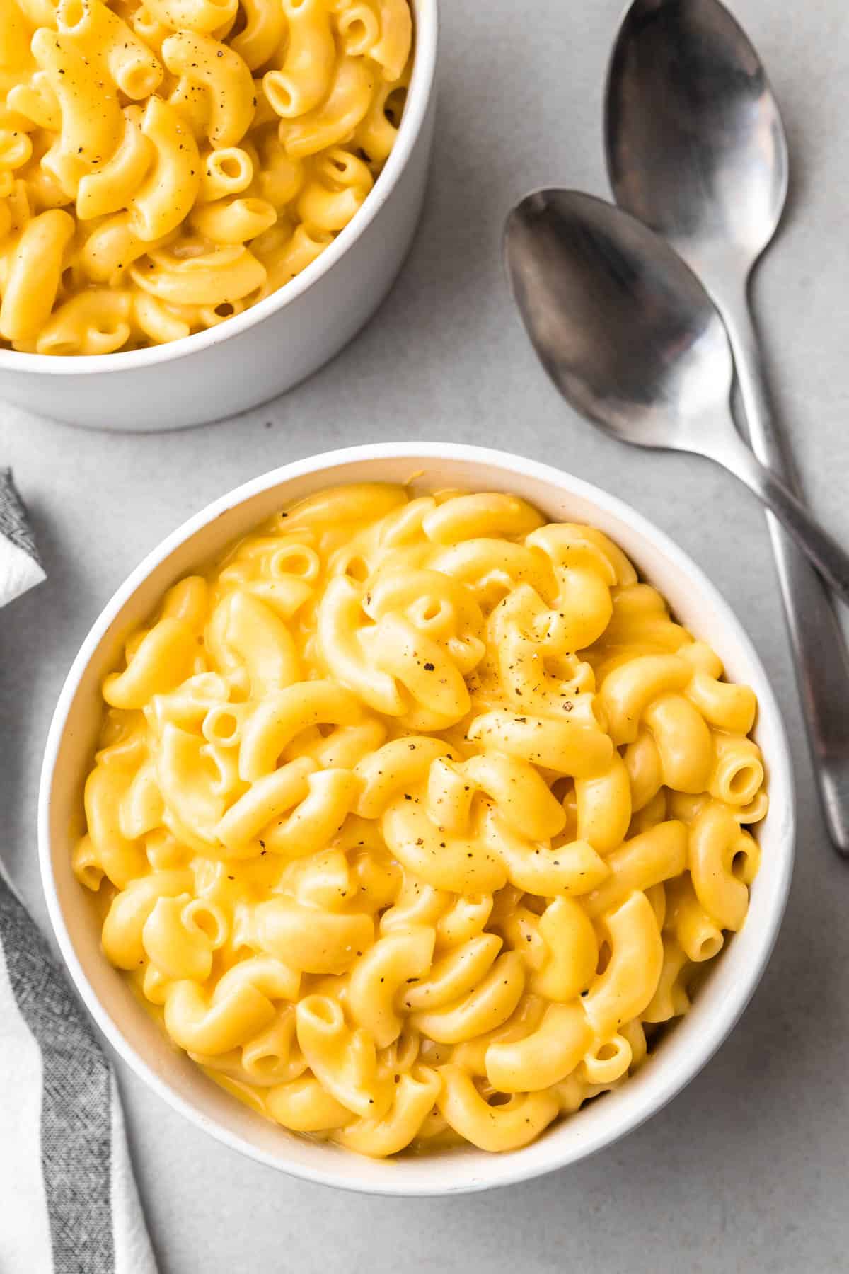 creamy Mac and cheese in a white bowl with spoons