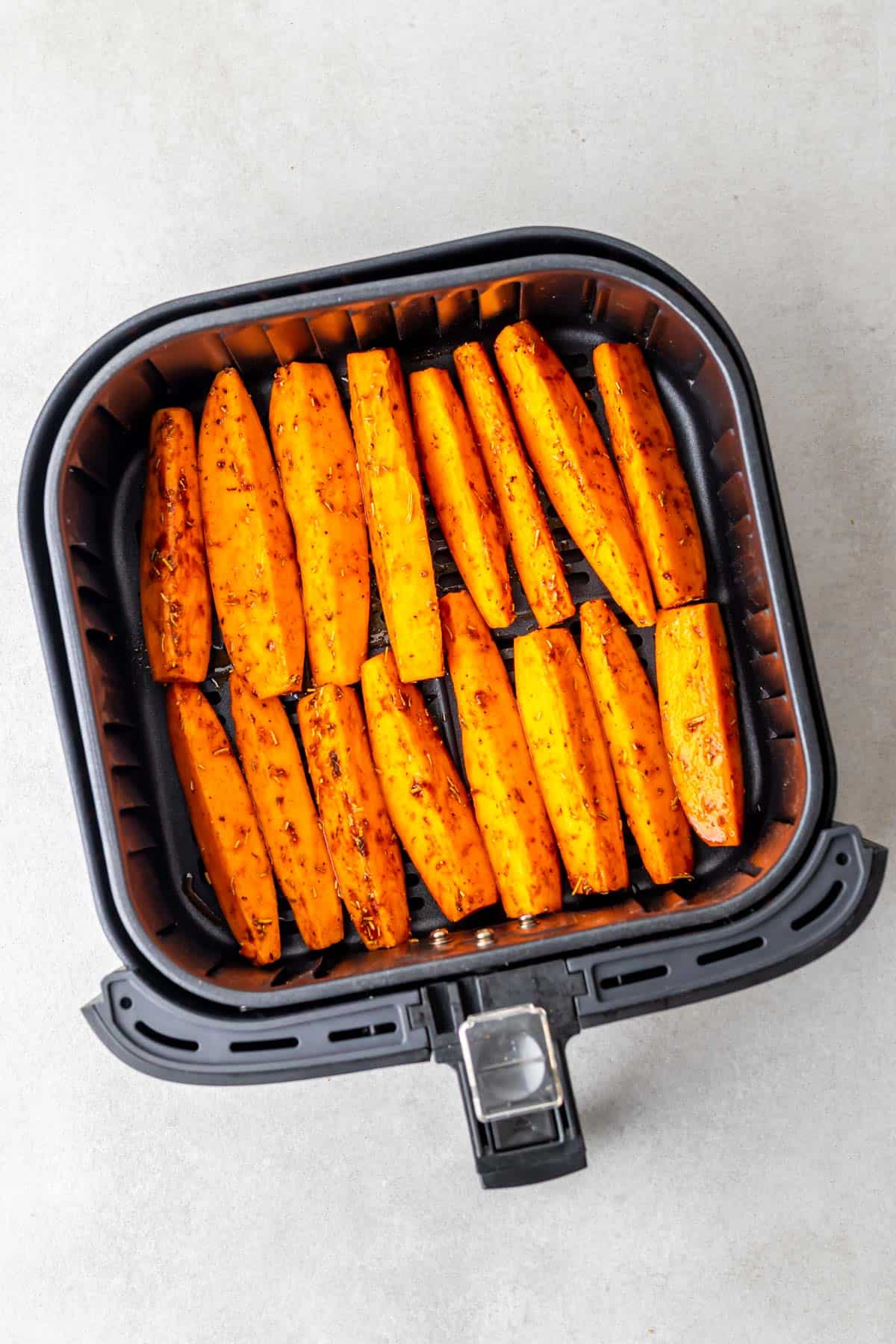 sweet potato wedges in the air fryer ready to be cooked