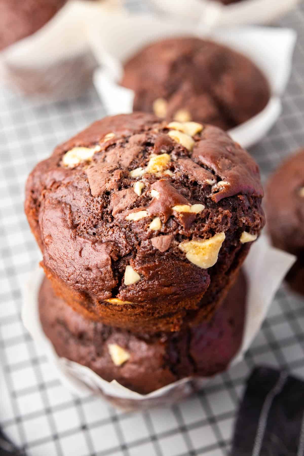 two chocolate muffins stacked on top of each other