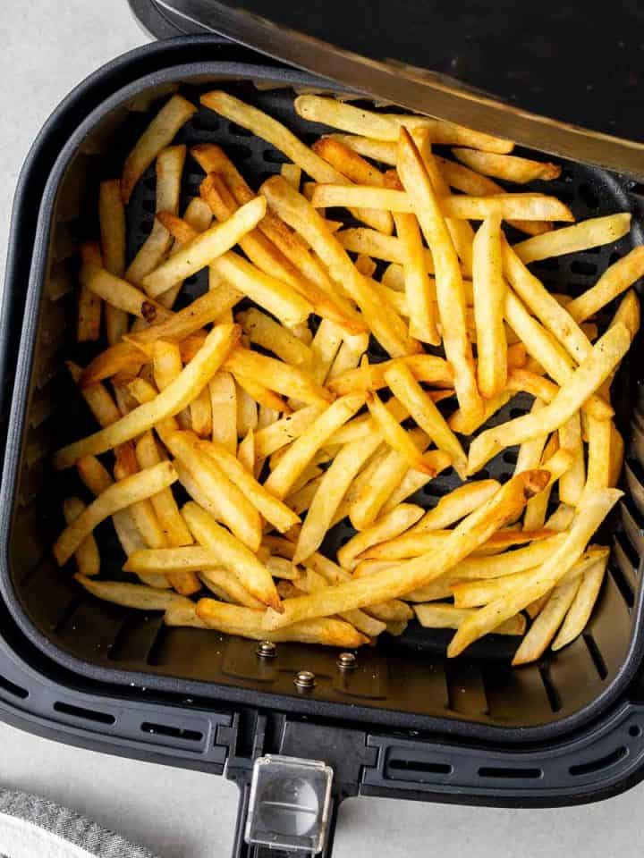 golden and crispy french fries in air fryer basket