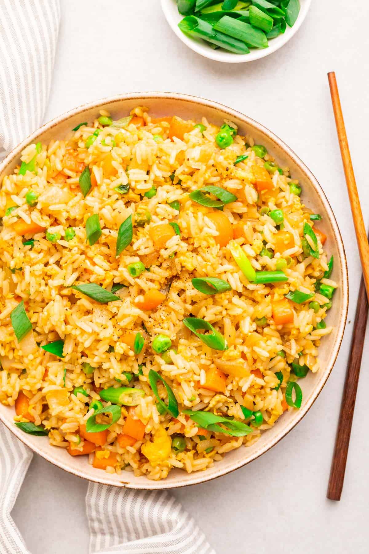 close up of the egg fried rice with wooden chopsticks