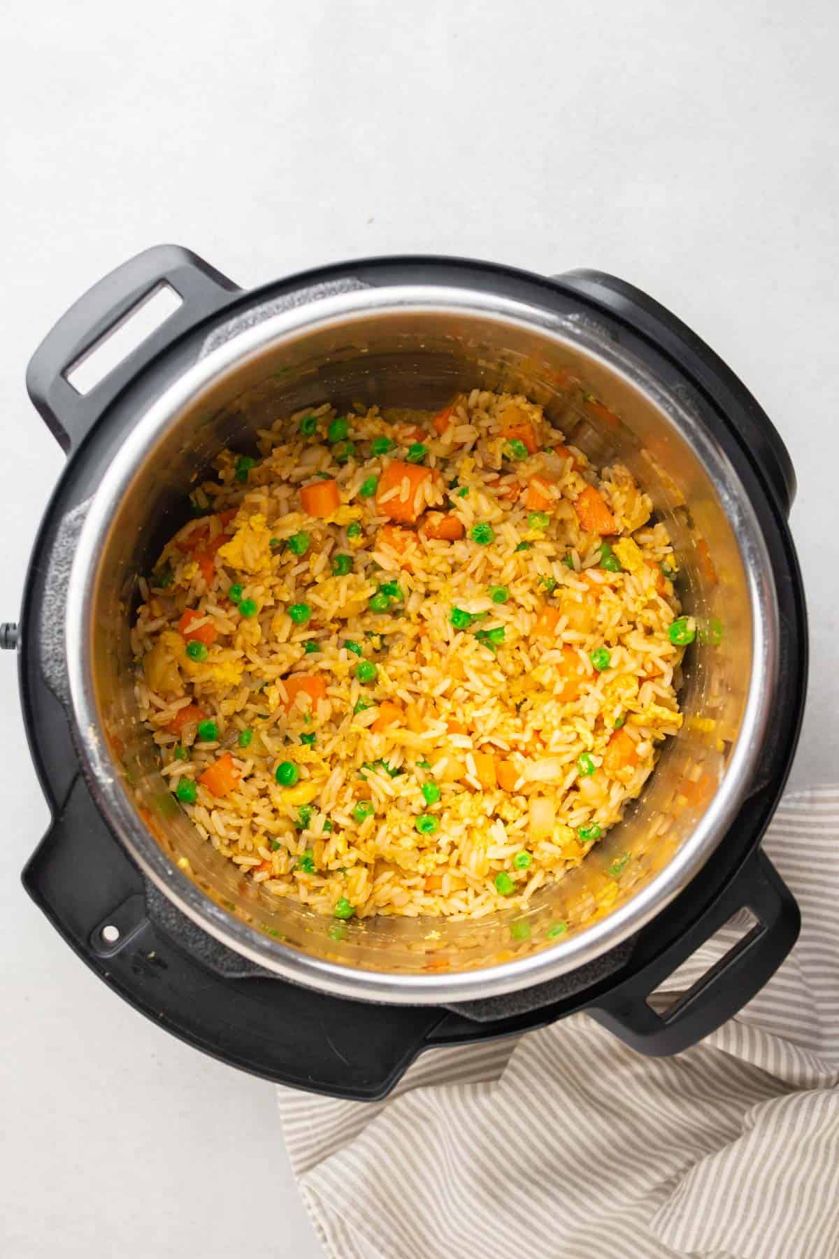 instant pot with cooked fried rice and cloth