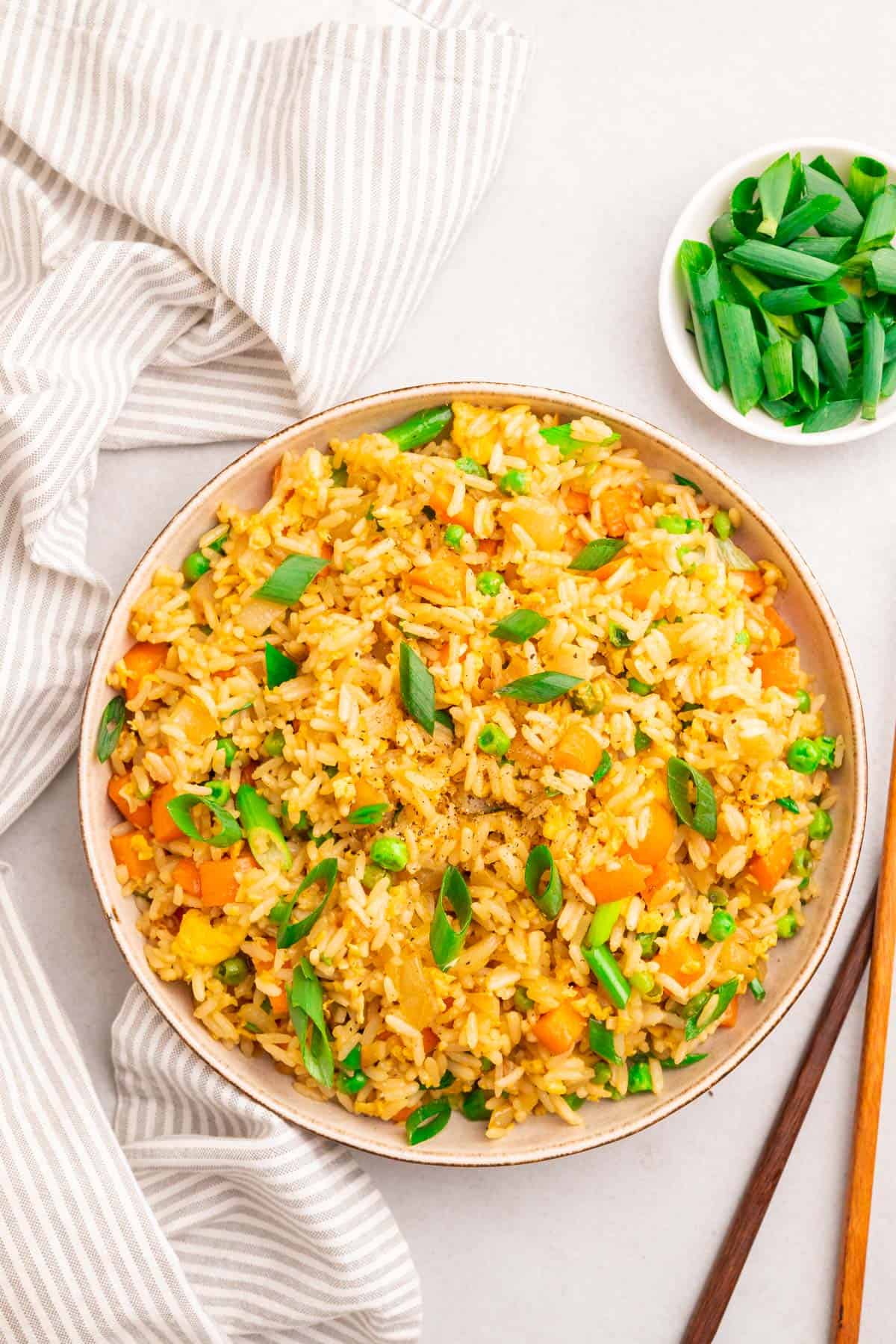 instant pot fried rice with green onions, cloth and chopsticks