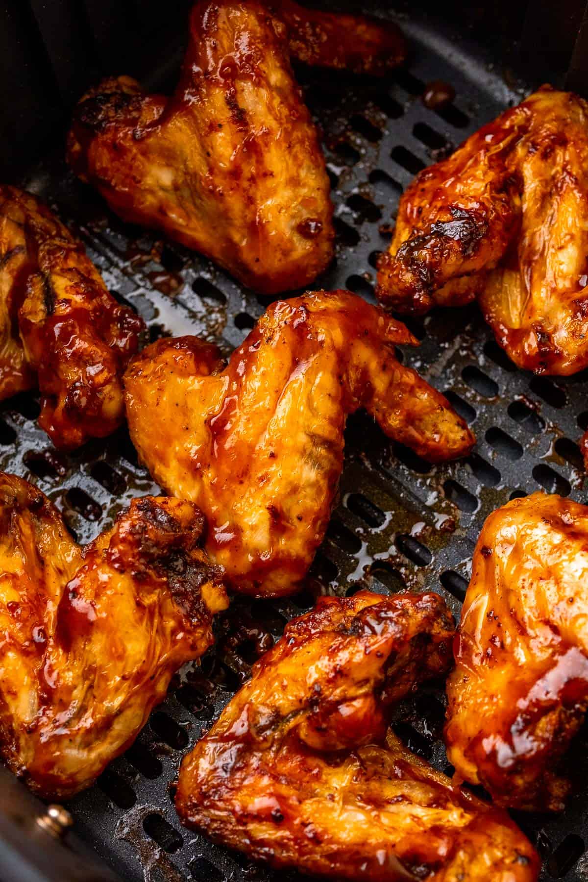 close up of the bbq sauce glazed chicken wings in the air fryer basket