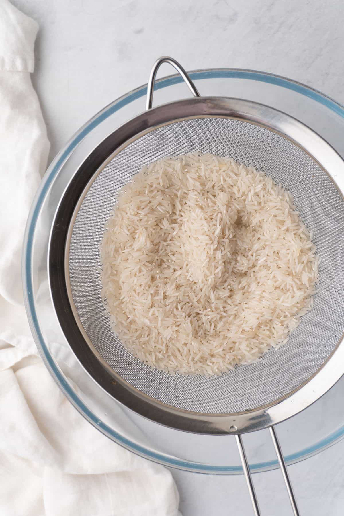 rice being rinsed with cold water