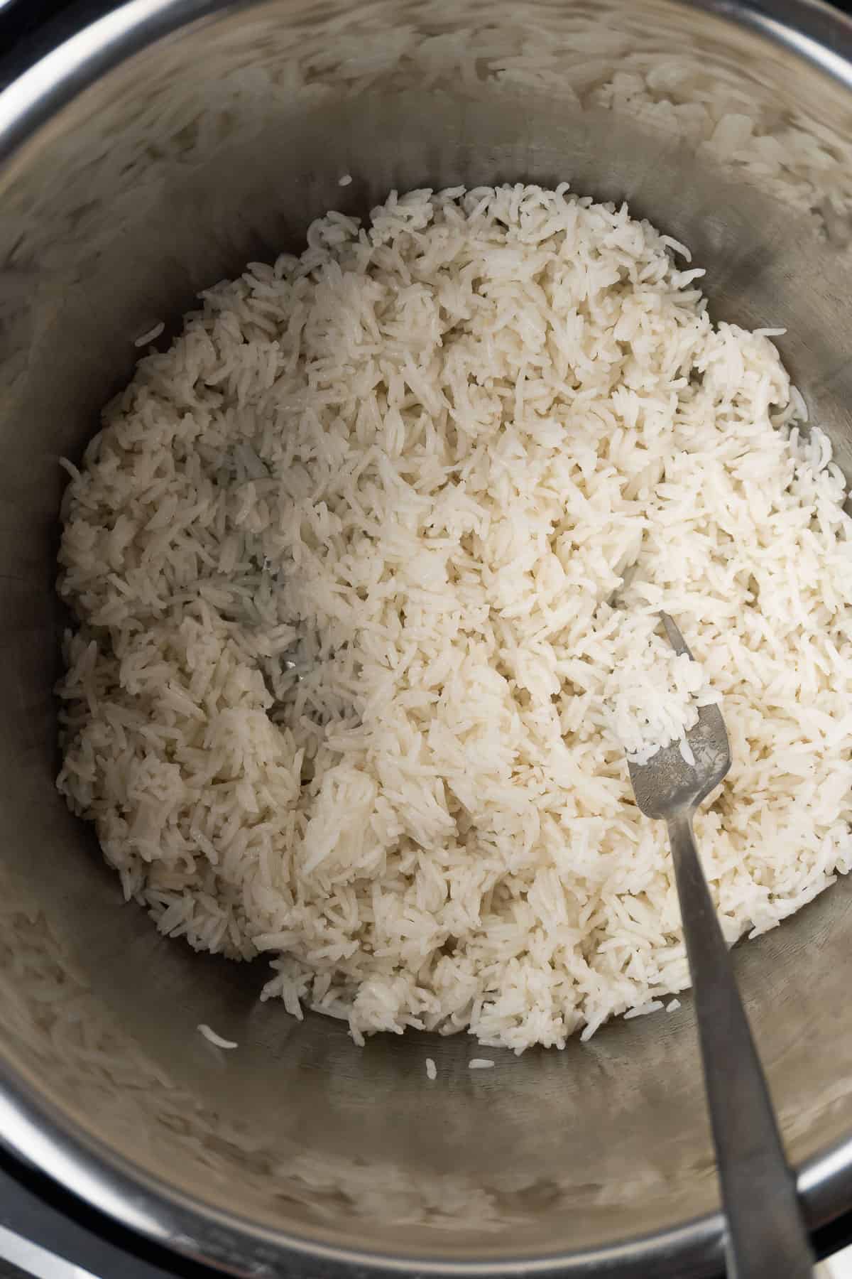 close up of the cooked rice fluffed with a fork in the Instant Pot
