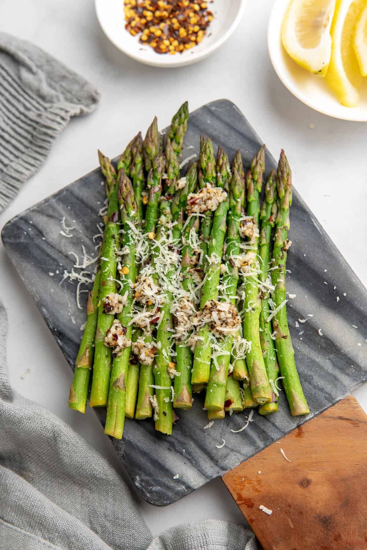 asparagus served with freshly grated parmesan, lemon wedges and chilli flakes