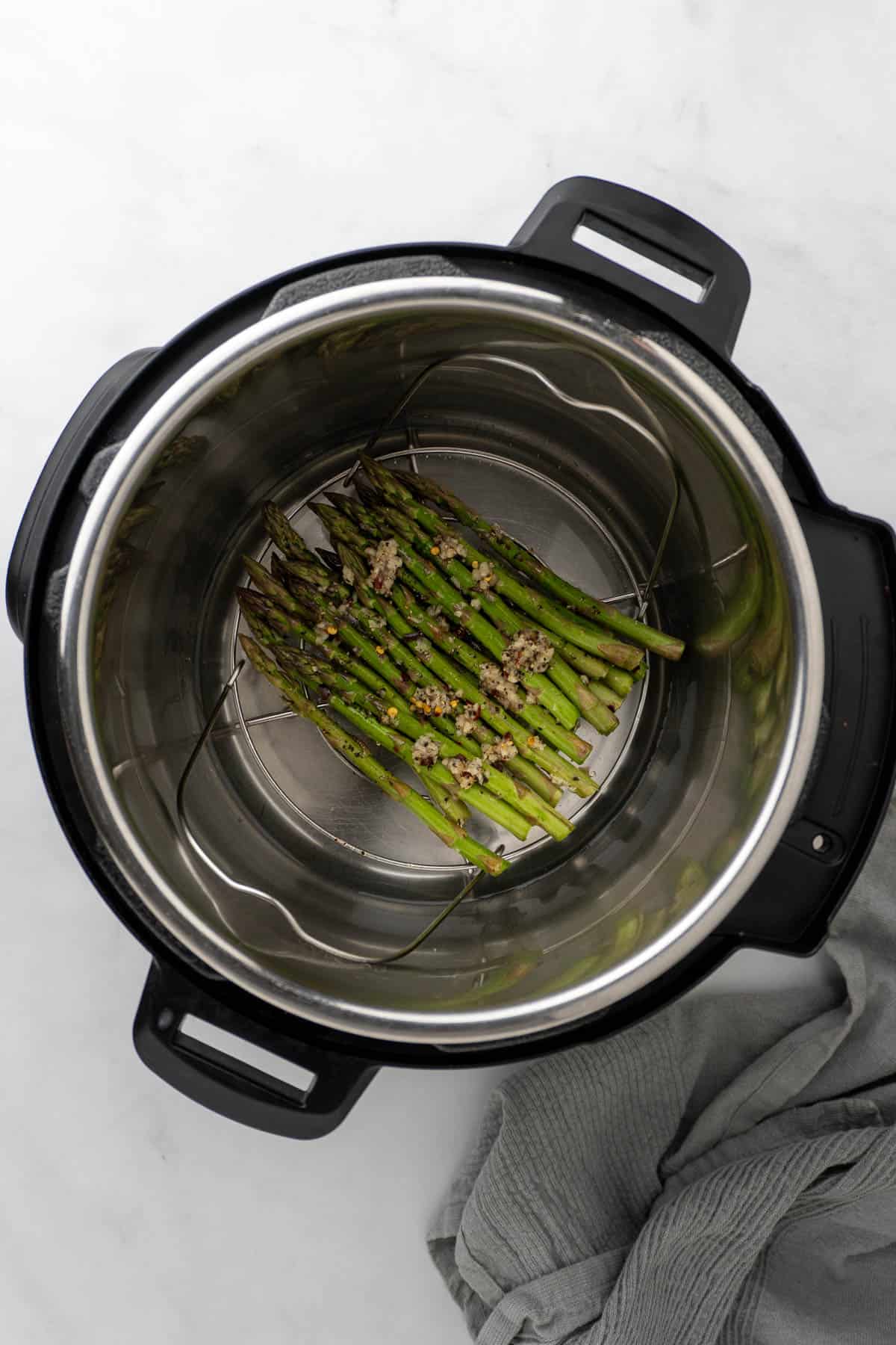 seasoned asparagus spears in the Instant Pot, on the metal trivet, before being cooked