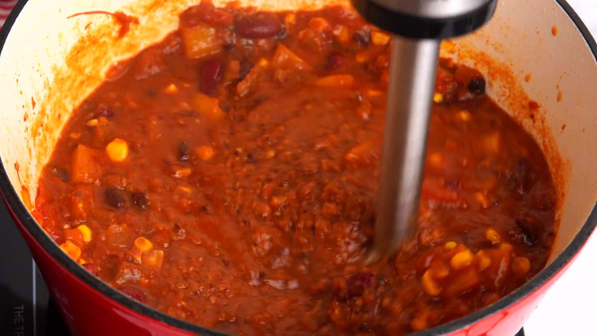 using an immersion blender to smooth some of the chili for a thicker texture 