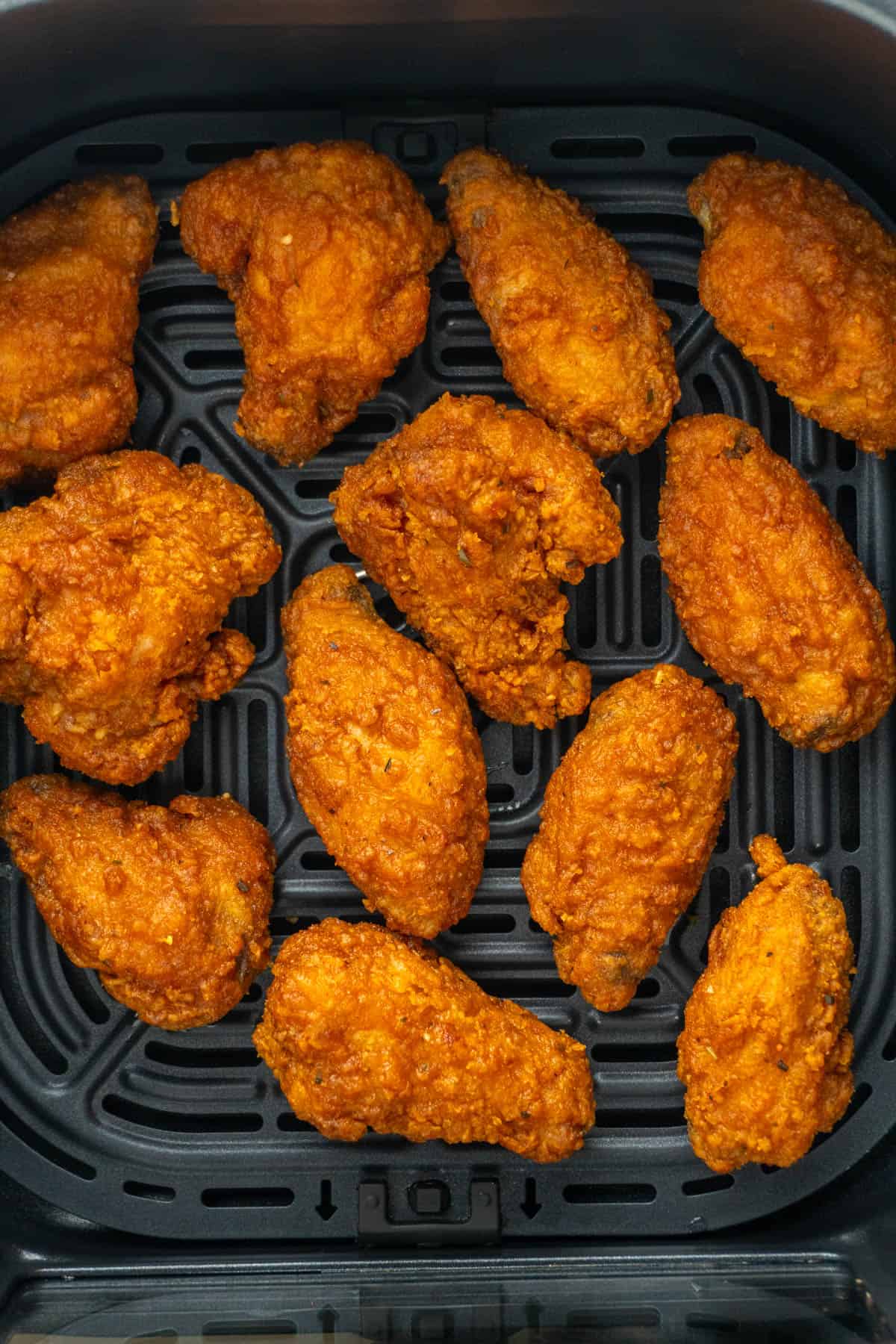 Close-up shot of the chicken wings in the air fryer basket.